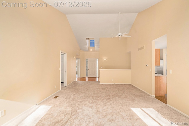 7031 Iris Ct Unit 3, Grand Blanc, MI 48439 - unfurnished living room with high vaulted ceiling, light carpet, and a ceiling fan