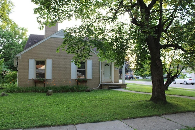 2906 Syracuse St, Dearborn, MI 48124 - view of front of property featuring brick siding, a chimney, and a front lawn