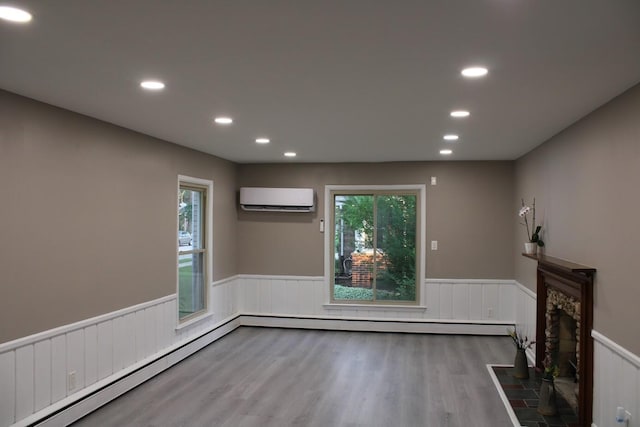 2906 Syracuse St, Dearborn, MI 48124 - unfurnished living room with a wall mounted air conditioner, wainscoting, a baseboard radiator, wood finished floors, and healthy amount of natural light