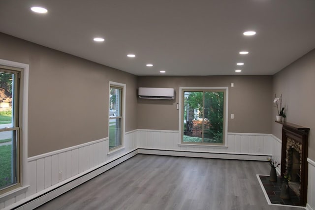 2906 Syracuse St, Dearborn, MI 48124 - unfurnished living room featuring wainscoting, a wall unit AC, a baseboard radiator, recessed lighting, and wood finished floors