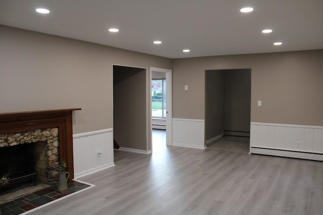 2906 Syracuse St, Dearborn, MI 48124 - unfurnished living room with a wainscoted wall, light wood-type flooring, a baseboard radiator, baseboard heating, and recessed lighting