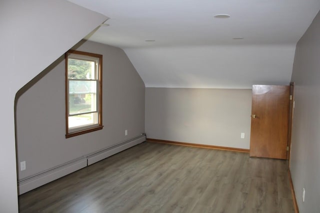 2906 Syracuse St, Dearborn, MI 48124 - additional living space with a baseboard radiator, light wood-type flooring, and lofted ceiling