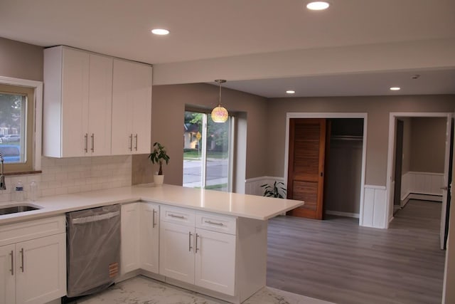 2906 Syracuse St, Dearborn, MI 48124 - kitchen featuring stainless steel dishwasher, a baseboard radiator, a peninsula, white cabinets, and wainscoting