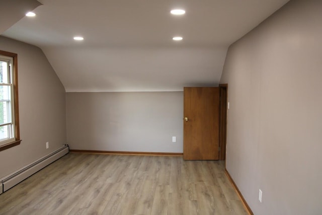 2906 Syracuse St, Dearborn, MI 48124 - additional living space with a baseboard heating unit, vaulted ceiling, plenty of natural light, recessed lighting, and light wood-style flooring