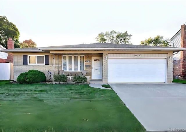 10352 Gulley St, Taylor, MI 48180 - ranch-style home with concrete driveway, a garage, covered porch, a front yard, and a chimney