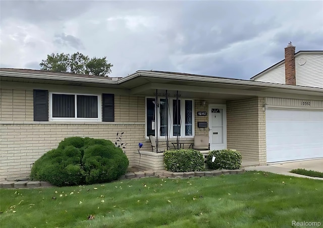 10352 Gulley St, Taylor, MI 48180 - ranch-style house featuring brick siding, a garage, a porch, and a front lawn