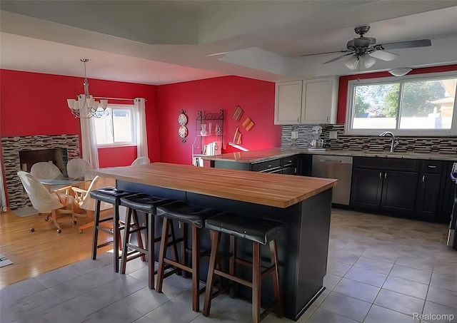 10352 Gulley St, Taylor, MI 48180 - kitchen with dishwasher, a peninsula, a kitchen breakfast bar, a chandelier, and decorative backsplash