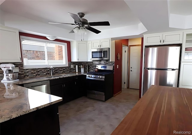 10352 Gulley St, Taylor, MI 48180 - kitchen featuring stainless steel appliances, tasteful backsplash, a ceiling fan, and light stone counters