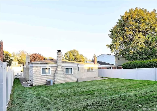 10352 Gulley St, Taylor, MI 48180 - back of property with a chimney, a fenced backyard, a patio area, and brick siding