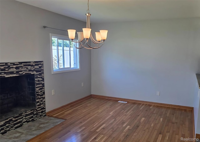 10352 Gulley St, Taylor, MI 48180 - unfurnished living room with hardwood / wood-style flooring, a chandelier, and a tile fireplace