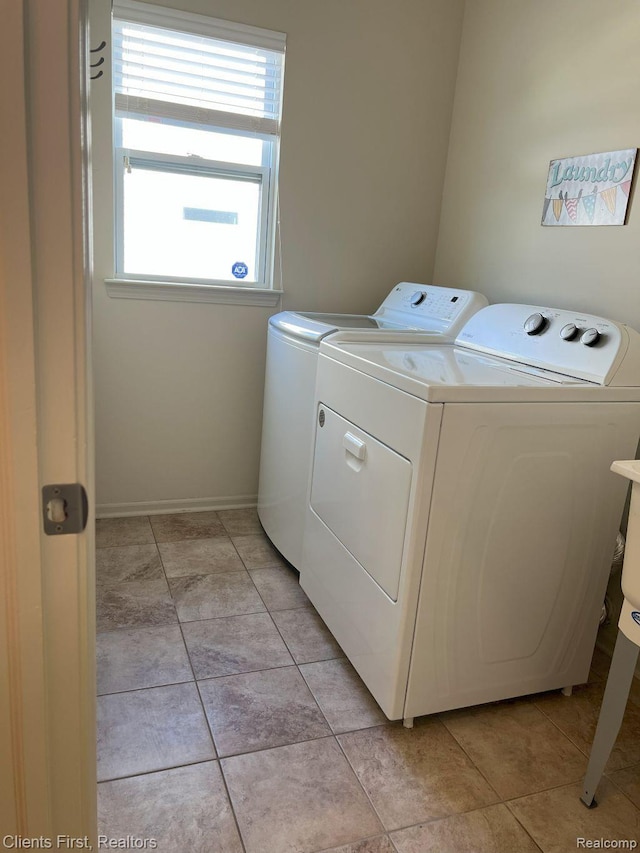 1082 Paddock Dr Unit 78, South Lyon, MI 48178 - laundry room with washing machine and clothes dryer and light tile patterned floors