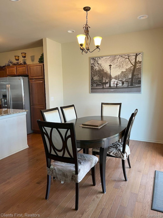 1082 Paddock Dr Unit 78, South Lyon, MI 48178 - dining room featuring light wood-type flooring and a chandelier