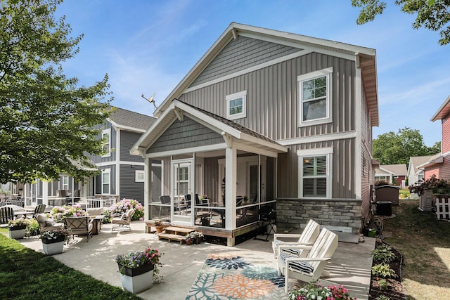 330 Rachaels Way, Spring Lake, MI 49456 - rear view of house featuring a patio, stone siding, and a sunroom