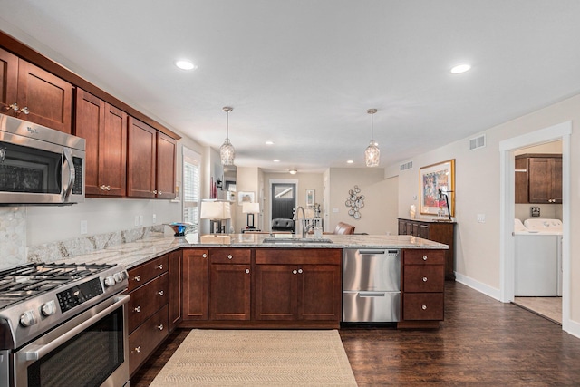 330 Rachaels Way, Spring Lake, MI 49456 - kitchen featuring stainless steel appliances, a peninsula, dark wood-style floors, washing machine and dryer, and recessed lighting