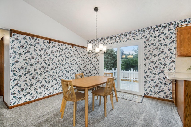 8728 Cottonwood Dr, Jenison, MI 49428 - dining space with wallpapered walls, a chandelier, lofted ceiling, and light colored carpet