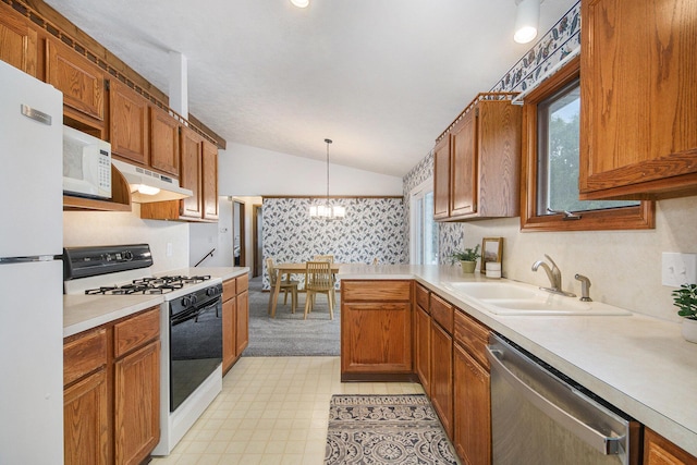 8728 Cottonwood Dr, Jenison, MI 49428 - kitchen with white appliances, under cabinet range hood, vaulted ceiling, light countertops, and pendant lighting