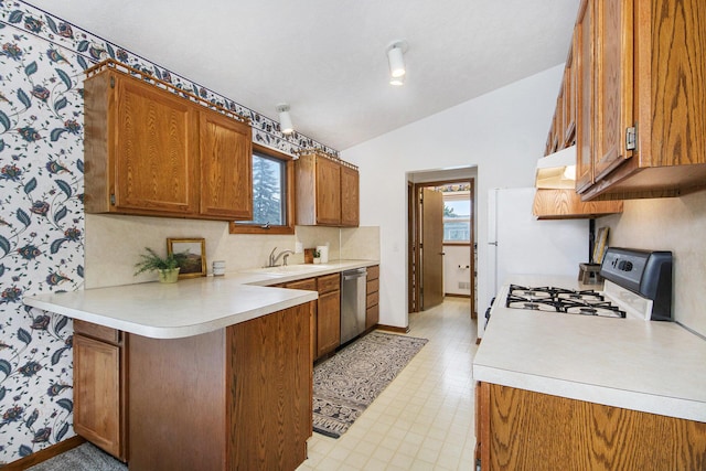 8728 Cottonwood Dr, Jenison, MI 49428 - kitchen featuring gas range, stainless steel dishwasher, lofted ceiling, brown cabinets, and light countertops