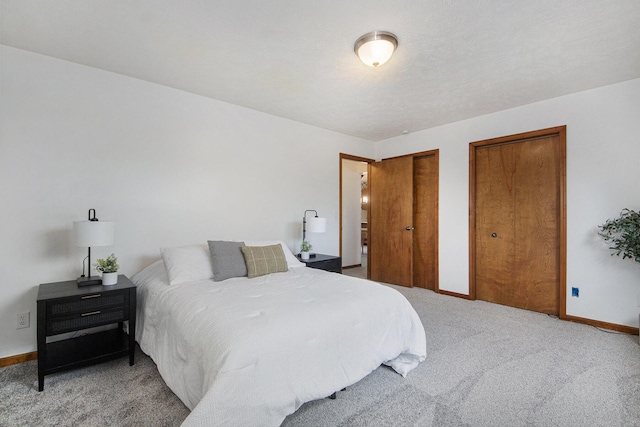 8728 Cottonwood Dr, Jenison, MI 49428 - carpeted bedroom featuring multiple closets and baseboards