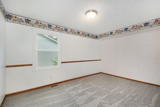 8728 Cottonwood Dr, Jenison, MI 49428 - carpeted empty room featuring baseboards and wallpapered walls