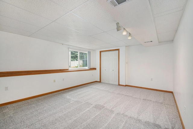 8728 Cottonwood Dr, Jenison, MI 49428 - carpeted spare room featuring a paneled ceiling and baseboards