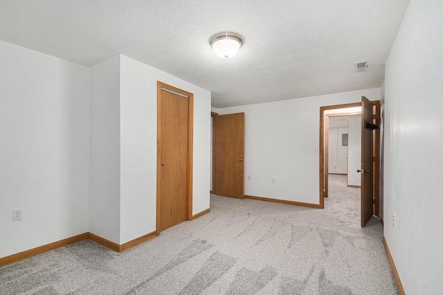 8728 Cottonwood Dr, Jenison, MI 49428 - unfurnished bedroom with light carpet, a closet, and a textured ceiling