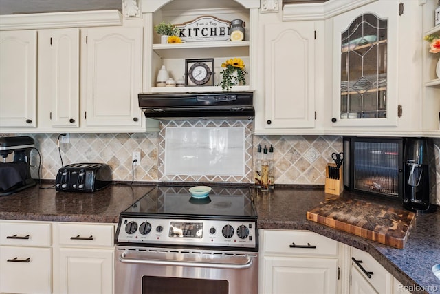 3439 N Mill Rd, Dryden, MI 48428 - kitchen with electric stove, dark countertops, range hood, and white cabinetry
