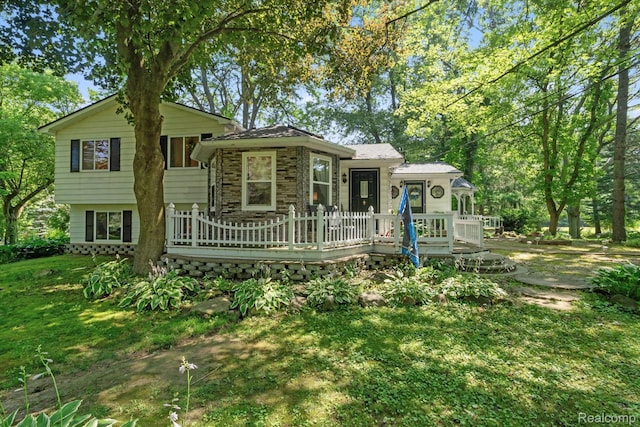 3439 N Mill Rd, Dryden, MI 48428 - split level home with a deck, stone siding, and a front yard