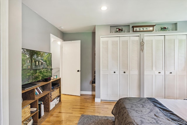 3439 N Mill Rd, Dryden, MI 48428 - bedroom featuring multiple closets, light wood-style floors, and recessed lighting