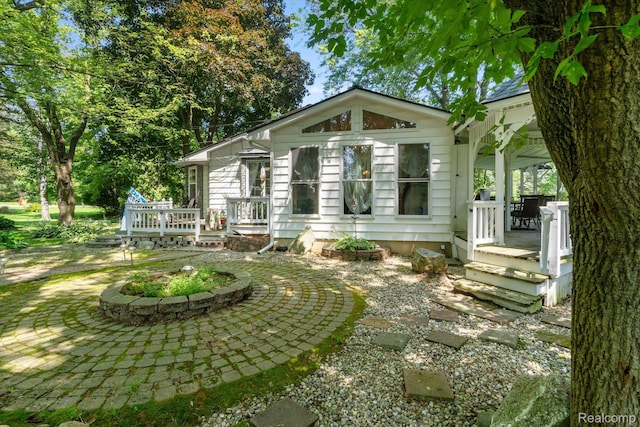 3439 N Mill Rd, Dryden, MI 48428 - rear view of property featuring a patio area and covered porch