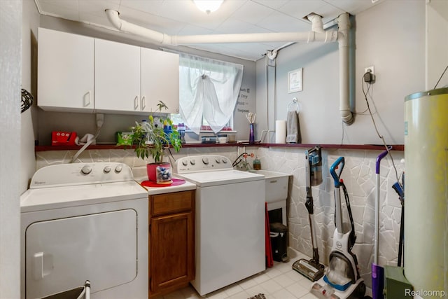 3439 N Mill Rd, Dryden, MI 48428 - laundry room with separate washer and dryer, cabinet space, water heater, and light tile patterned floors