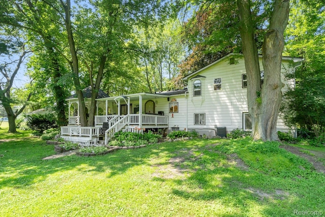 3439 N Mill Rd, Dryden, MI 48428 - back of property with covered porch and a yard