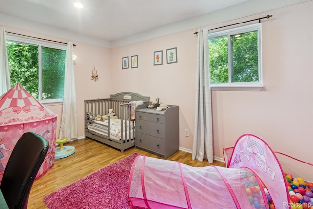 3439 N Mill Rd, Dryden, MI 48428 - bedroom featuring multiple windows and wood finished floors