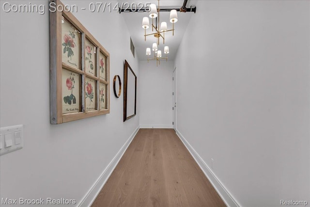2051 Villa Rd Unit 302, Birmingham, MI 48009 - hall with wood finished floors, a chandelier, and vaulted ceiling