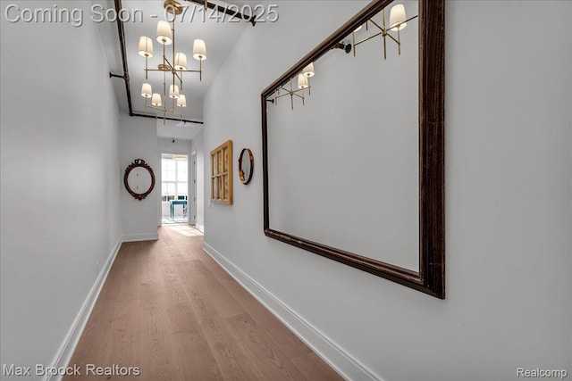 2051 Villa Rd Unit 302, Birmingham, MI 48009 - hallway featuring a chandelier and wood finished floors
