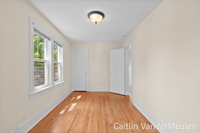 1340 Ashland Ave NE, Grand Rapids, MI 49505 - unfurnished bedroom with light wood-style flooring and baseboards