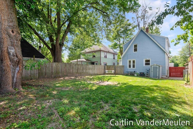 1340 Ashland Ave NE, Grand Rapids, MI 49505 - rear view of house with a fenced backyard, a chimney, and a storage shed