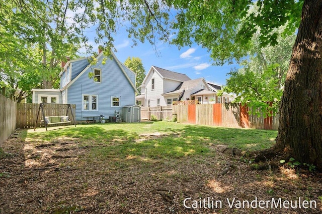 1340 Ashland Ave NE, Grand Rapids, MI 49505 - rear view of house with a shed, a fenced backyard, and a chimney