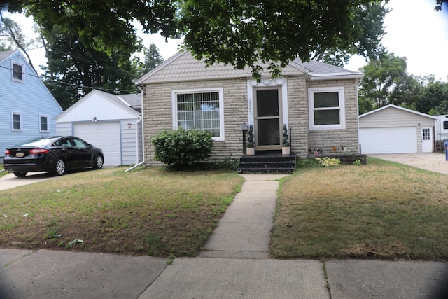 1122 Aberdeen St NE, Grand Rapids, MI 49505 - view of front facade with stone siding, a garage, an outbuilding, and a front yard