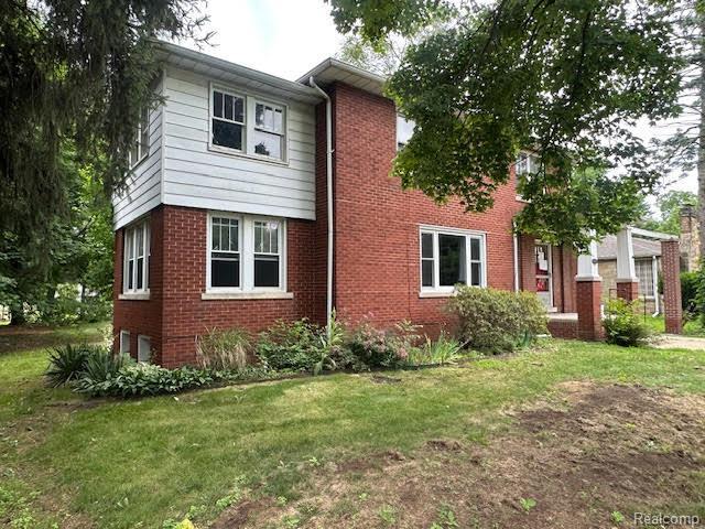 12100 Elmview St, Romulus, MI 48174 - view of front of home with brick siding and a front lawn