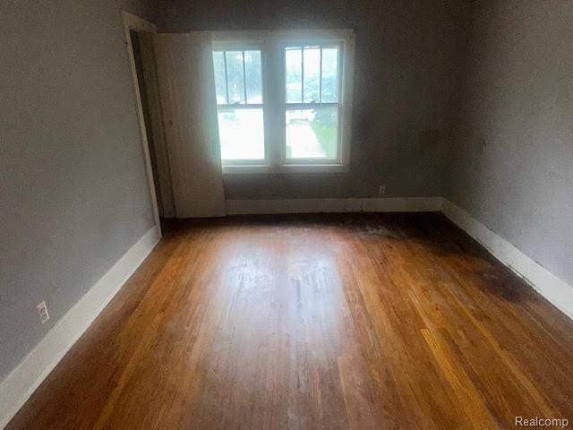 12100 Elmview St, Romulus, MI 48174 - spare room with wood finished floors and baseboards