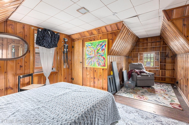35451 John St, Wayne, MI 48184 - bedroom featuring wood walls, vaulted ceiling, and hardwood / wood-style flooring