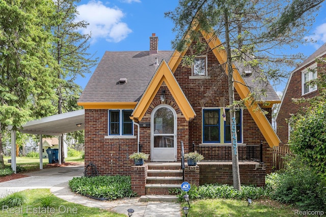 35451 John St, Wayne, MI 48184 - english style home featuring brick siding, a chimney, an attached carport, and a shingled roof