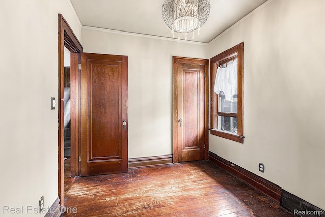 35451 John St, Wayne, MI 48184 - empty room featuring wood-type flooring, a chandelier, and ornamental molding