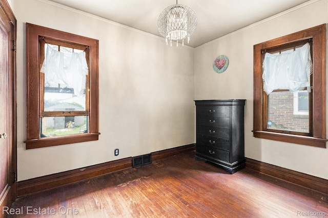 35451 John St, Wayne, MI 48184 - spare room featuring healthy amount of natural light, dark wood finished floors, a chandelier, and ornamental molding