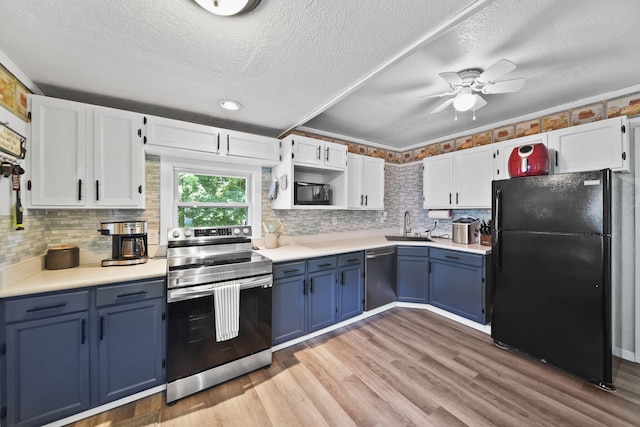 350 N Horton St, Jackson, MI 49202 - kitchen featuring black appliances, blue cabinetry, white cabinets, ceiling fan, and a textured ceiling