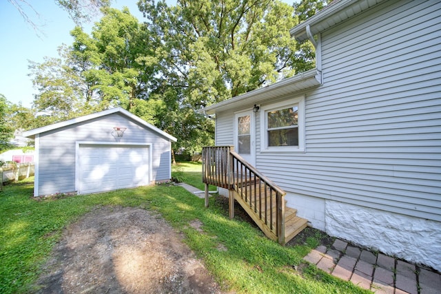 350 N Horton St, Jackson, MI 49202 - view of grassy yard with an outbuilding, a detached garage, and driveway