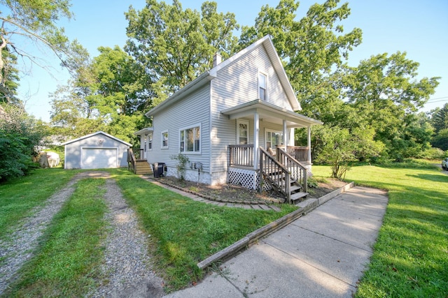 350 N Horton St, Jackson, MI 49202 - view of front of home featuring an outdoor structure, a garage, a front lawn, driveway, and a porch