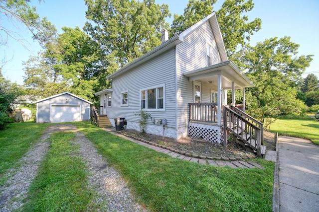 350 N Horton St, Jackson, MI 49202 - view of front of house with an outdoor structure, covered porch, a detached garage, driveway, and a chimney