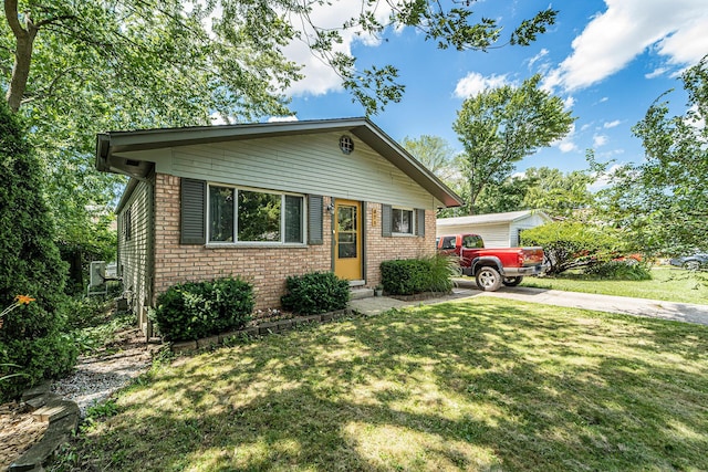 471 Dupont Ave, Ypsilanti, MI 48197 - bungalow with brick siding, a front yard, and driveway