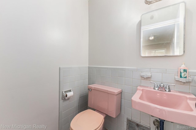 23306 Greencrest St, Saint Clair Shores, MI 48080 - bathroom featuring tile walls and wainscoting